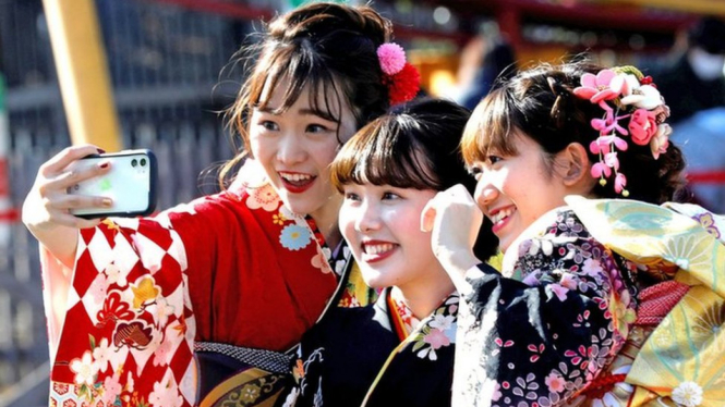 Japanese women wearing kimonos take selfies as they attend their Coming of Age Day celebration ceremony at Toshimaen amusement park in Tokyo, Japan, January 13, 2020.REUTERS/Kim Kyung-Hoon - Reuters