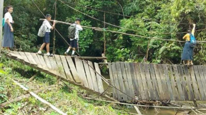Anak-anak sekolah melewat jembatan ambruk di Bengkayang, Kalimantan Barat.