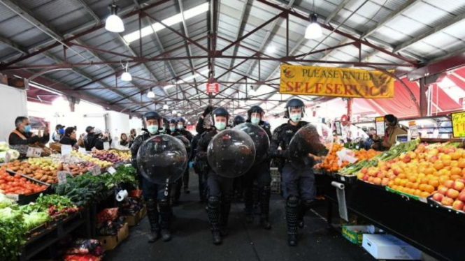 Polisi memindahkan pengunjuk rasa keluar dari Queen Victoria Market di tengah unjuk rasa anti-lockdown di Melbourne, Minggu, 13 September 2020.