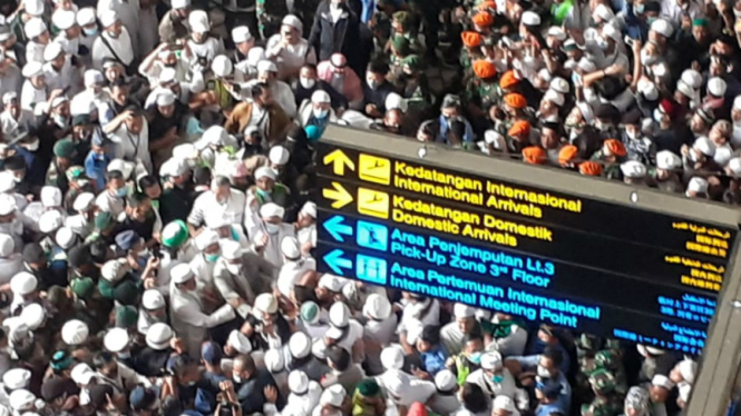 Massa simpatisan menyambut kedatangan Habib Rizieq Shihab di Soetta