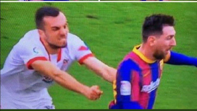 Gelandang Sevilla, Joan Jordan sedang berusaha menghentikan Lionel Messi. 