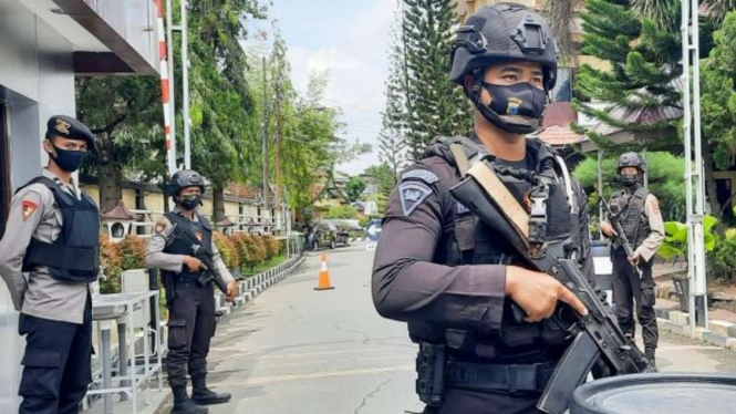 Polisi bersenjata lengkap menjaga pintu masuk Markas Kepolisian Daerah Kalimantan Selatan di Banjarmasin pada Kamis, 1 April 2021.