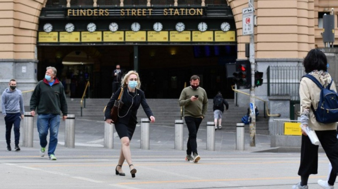 Warga Australia memakai masker berjalan di kawasan CBD Melbourne di Victoria.