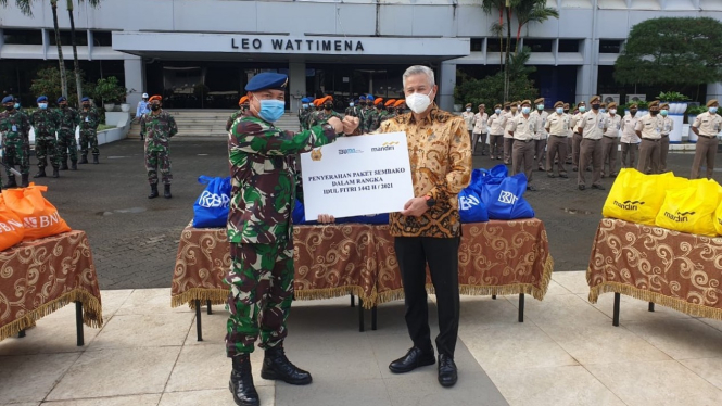 Corporate Secretary Bank Mandiri Rudi As Aturridha saat menyerahkan paket sembako ke salah satu anggota TNI.