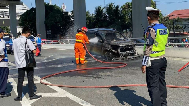 Mobil terbakar di Tol Dalam Kota, Senin, 26 Juli 2021.