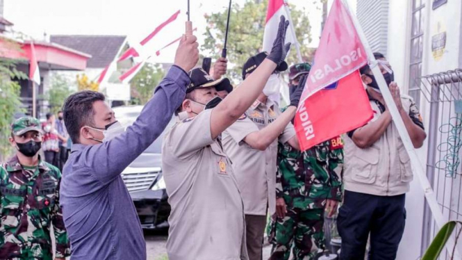 Bupati Jember pasang bendera merah ke warga yang isoman.