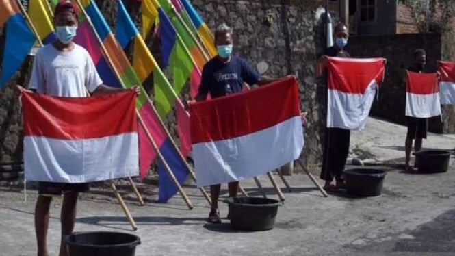 Sejumlah warga melakukan tradisi unik mencuci bendera Merah Outih secara bersama untuk menyambut HUT ke-76 Kemerdekaan RI di Dukuh Beji, Desa Sidomulyo Ampel, Kabupaten Boyolali, Jawa Tengah, Minggu, 8 Agustus 2021.