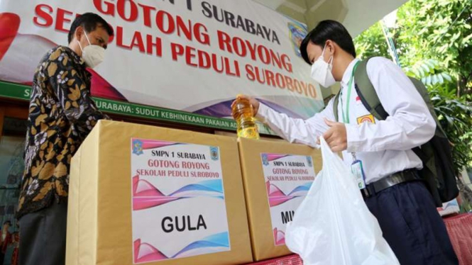 Pelajar di Surabaya memasukkan bantuan kebutuhan pokok untuk penanganan COVID-19