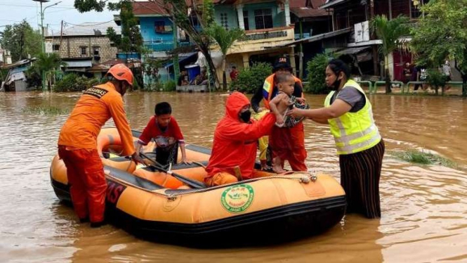 Petugas Basarnas mengevakuasi warga yang terjebak banjir di permukiman kawasan Kali Acai, Distrik Abepura, Kota Jayapura, Provinsi Papua, Jumat, 7 Januari 2022.