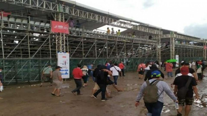 Sejumlah orang berjalan melintasi area luar sirkuit MotoGP di Mandalika, Kabupaten Lombok Tengah, Nusa Tenggara Barat, setelah hujan deras mengguyur kawasan itu.