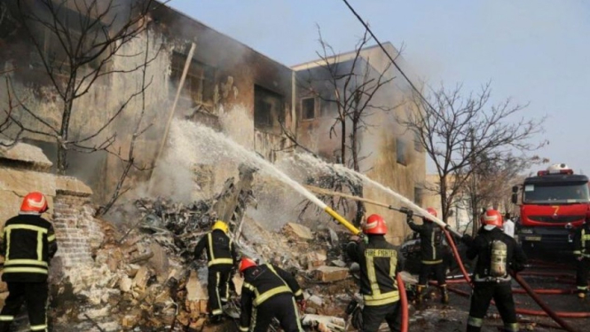Petugas pemadam kebakaran berupaya memadamkan api setelah sebuah jet tempur jatuh di Tabriz, Iran, 21 Februari 2022.