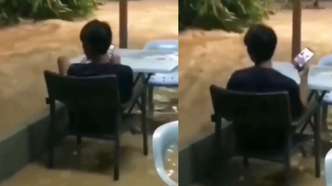 Viral seorang pemuda santai duduk walaupun banjir