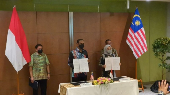 Menaker RI Ida Fauziyah (kanan) dan Menteri Sumber Daya Manusia Malaysia M. Saravanan Murugan (kiri) menandatangani MoU tentang Penempatan dan Pelindungan Pekerja Migran Indonesia Sektor Domestik di Malaysia pada Kamis (28/7/2022).
