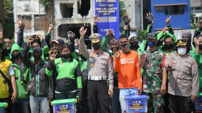 Korlantas Polri membagikan paket sembako kepada masyarakat yang membutuhkan