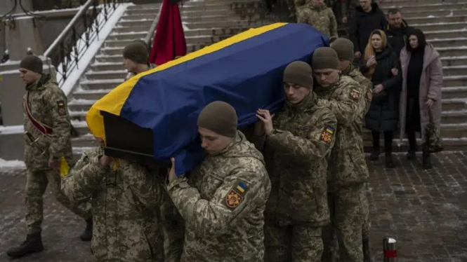 Tentara Ukraina membawa jenazah tentara yang tewas dalam perang melawan Rusia.