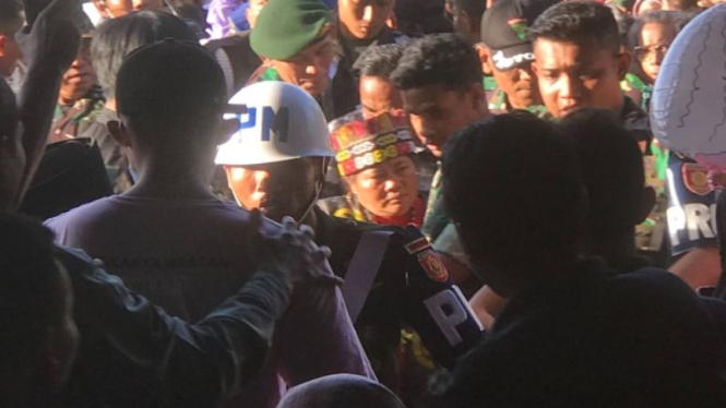 Ida Dayak diamankan aparat TNI di tengah kerumunan warga yang ricuh.
