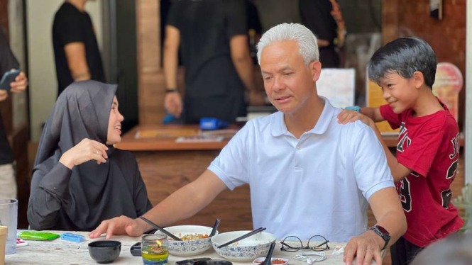 Bakal calon presiden Ganjar Pranowo, saat bersama sang istri Siti Atikoh dan anaknya Muhammad Zinedine Alam Ganjar, dipijat oleh seorang anak kala mereka makan siang bersama di satu restoran di Jakarta Selatan, Sabtu, 21 Oktober 2023.