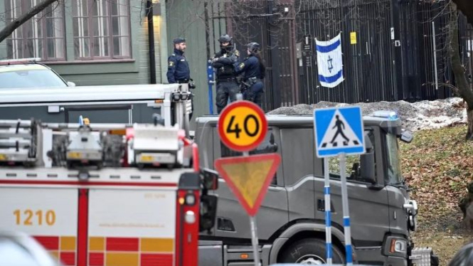 Police officers stand near the Israeli embassy, on the day an object believed to be an explosive device was found and destroyed by the national bomb squad according to police, in Stockholm, Sweden, on January 31, 2024. (Reuters)