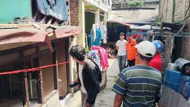 warga melintas menyaksikan rumah meledak akibat tabung gas